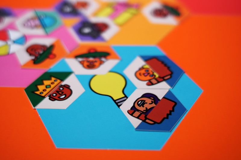 Hexagonal game cards on an orange table